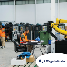 Engineers programming and testing robotic arm in modern factory