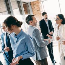 Group of diverse professionals networking and collaborating during a business meeting in a modern office environment 