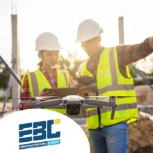 Construction workers using a drone