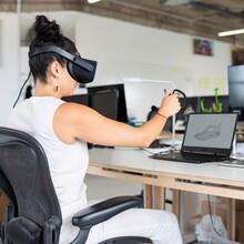 Woman with virtual reality headset in an office