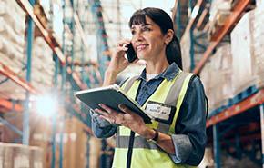 Logistics, tablet or woman with phone call in warehouse 