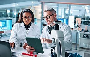 Collaboration, tablet or science with people in lab together for research or development. 