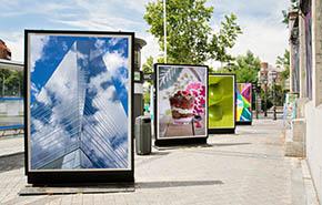 Billboards with photographs at city street